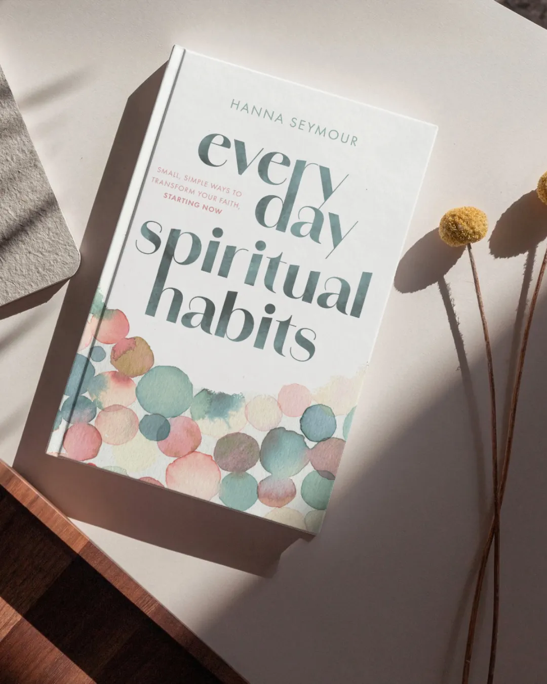 Everyday Spiritual Habits book by Hanna Seymour on table with dried flowers